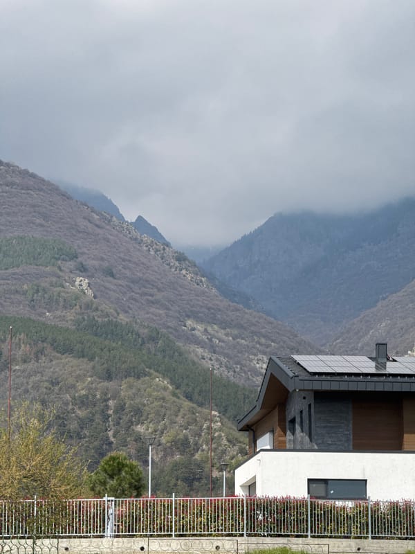Person in athletic wear walks paths near Bulgarian mountain homes