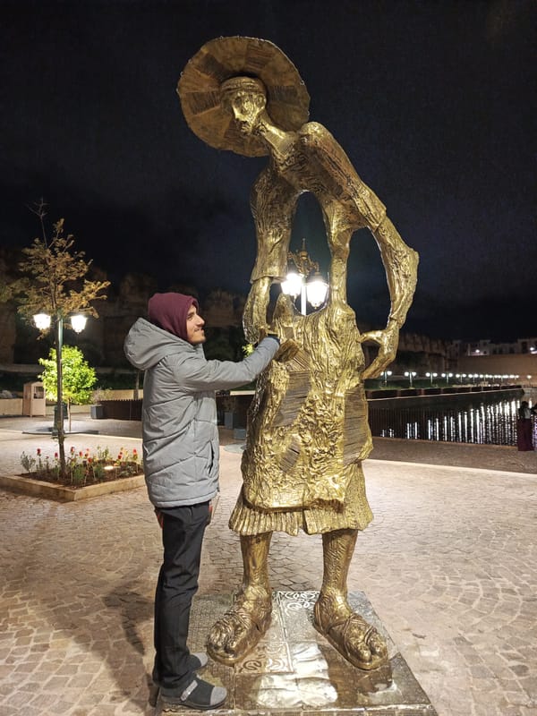 Man stands by illuminated fountains in Morocco evening