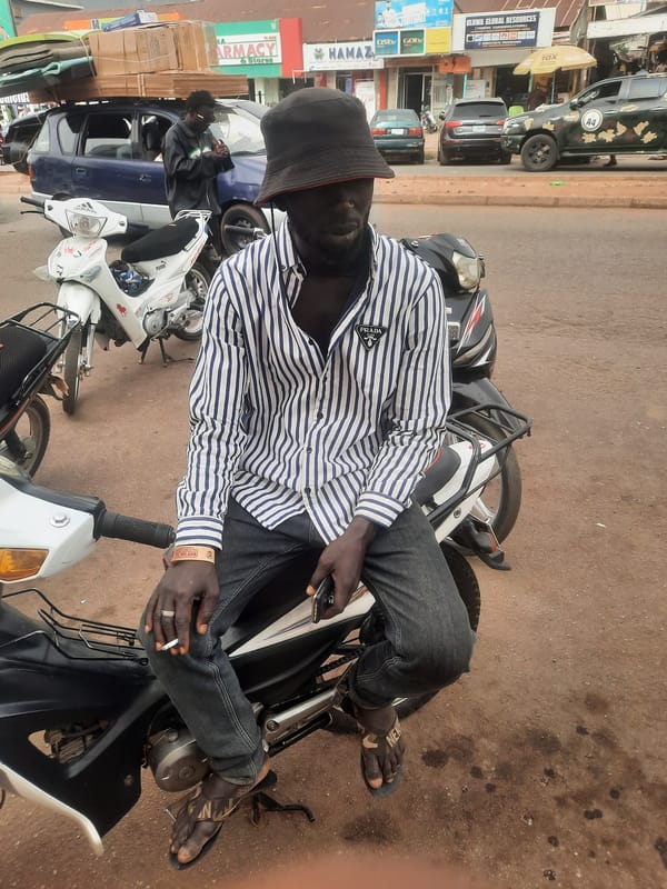 Man sits on motorcycle in Jos, Nigeria