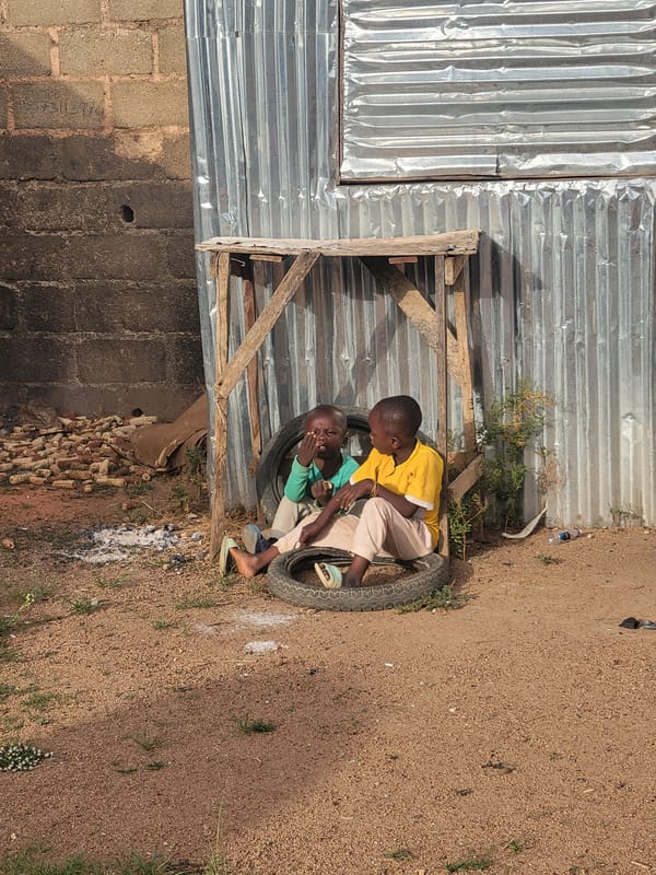 Boys play on tires in Nigerian village