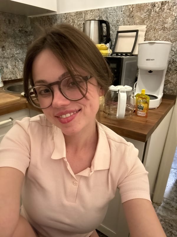 Woman takes cheerful kitchen selfies in Budapest