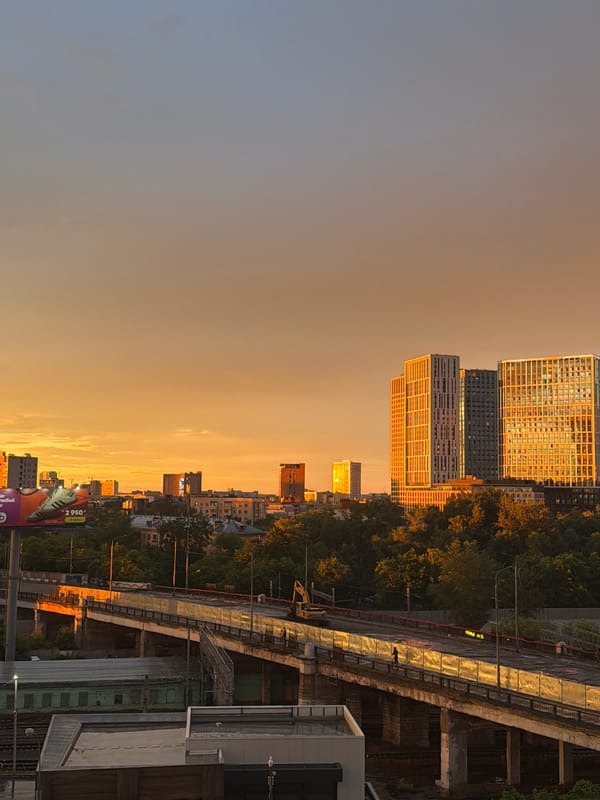 Rainbow and golden sunset over Moscow's residential skyline