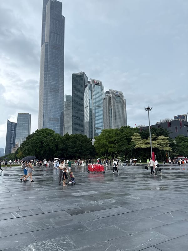 Rainy morning crowds fill Canton Tower plaza in Guangzhou