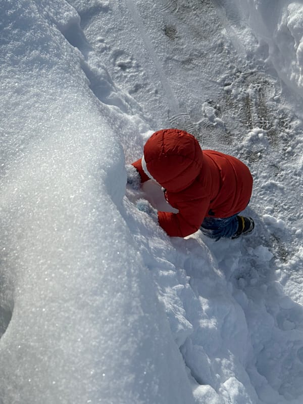 Child plays in snow on winter morning in Perm