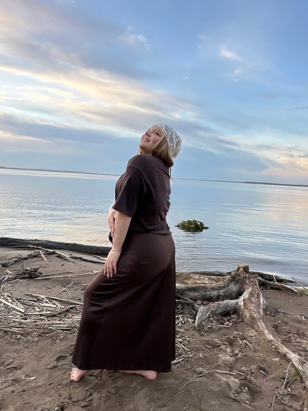 Woman in traditional dress observed by Kama River in Chaikovsky