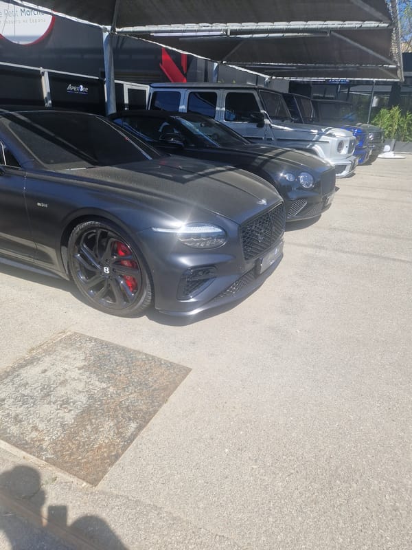 Luxury car lineup spotted in outdoor parking area