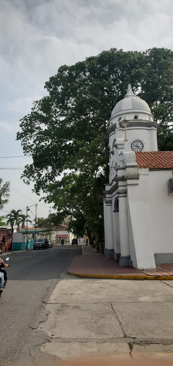 Motorcyclist rides past colonial building in Cabudare, Venezuela