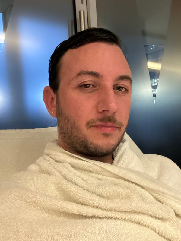 Man in towel spotted in London indoor setting