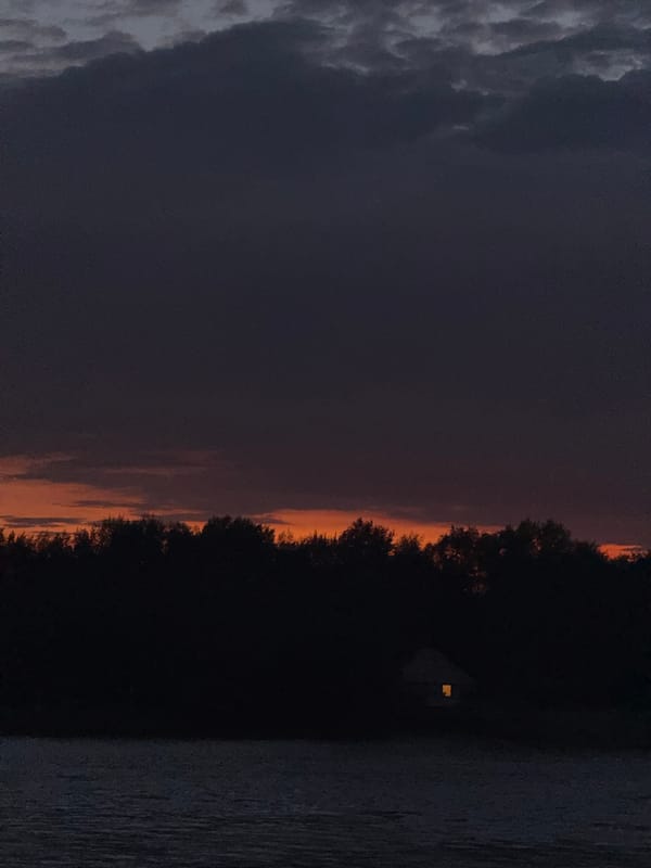 Pavlodar waterfront at dusk, with a cat nap on the side