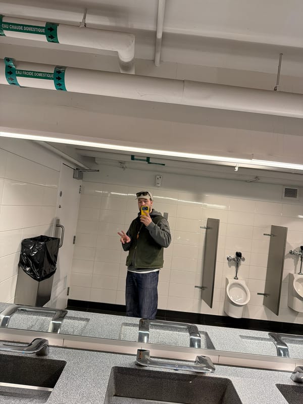 Person Takes Mirror Selfie in Montreal Public Restroom