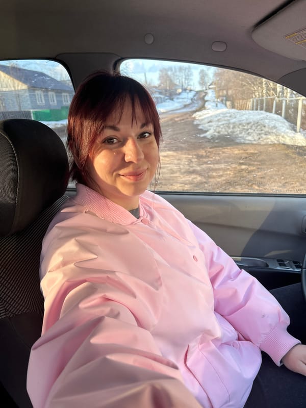 Woman poses in Mitsubishi on snowy Russian street