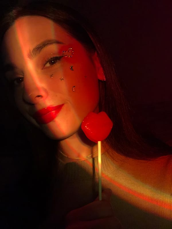 Woman photographed in red-lit portrait session in Noviy