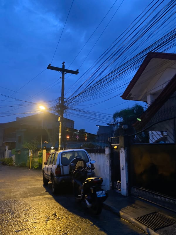 Wet streets and dusk light across a Davao City neighborhood