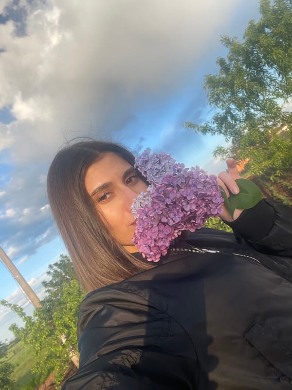 Couple photographs with lilac flowers during Sofia sunset