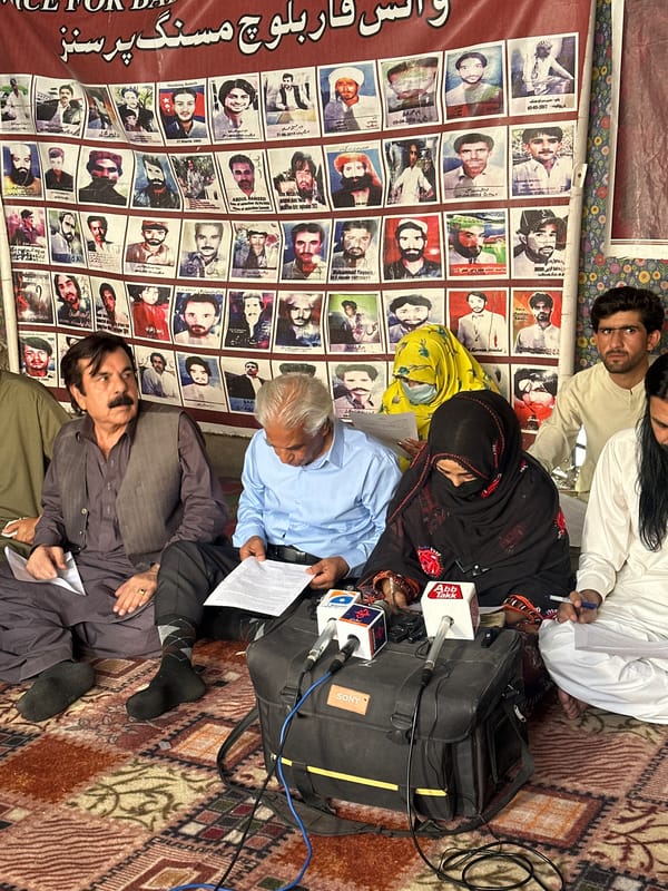 Tent gathering in Quetta features banner of photographed faces