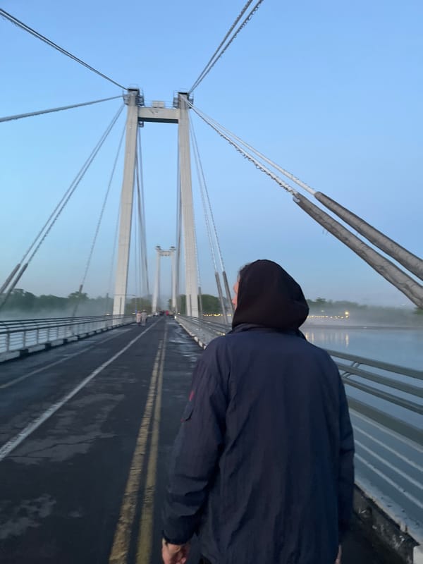 Foggy afternoon pedestrian activity on Krasnoyarsk's Vinogradovsky Bridge