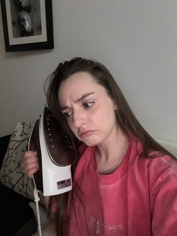 Woman holds iron to face in Kragujevac apartment