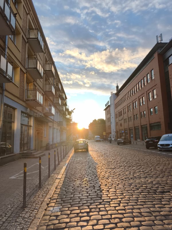 Gdańsk at golden hour, streets and station glowing at dusk