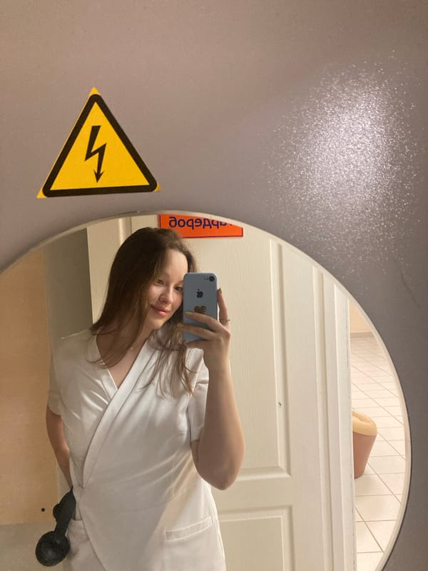 Woman takes mirror selfie in Chaikovsky public restroom
