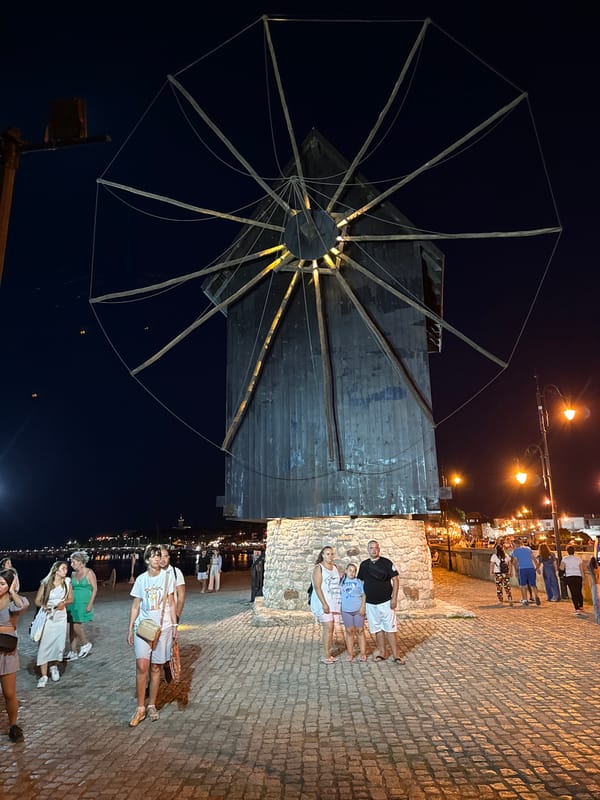 Nesebar old town at dusk: windmill, fortress walls, and street life