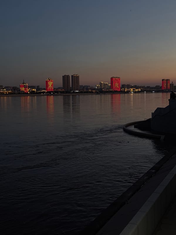 Blagoveshchensk waterfront at dusk, Amur River lighting up