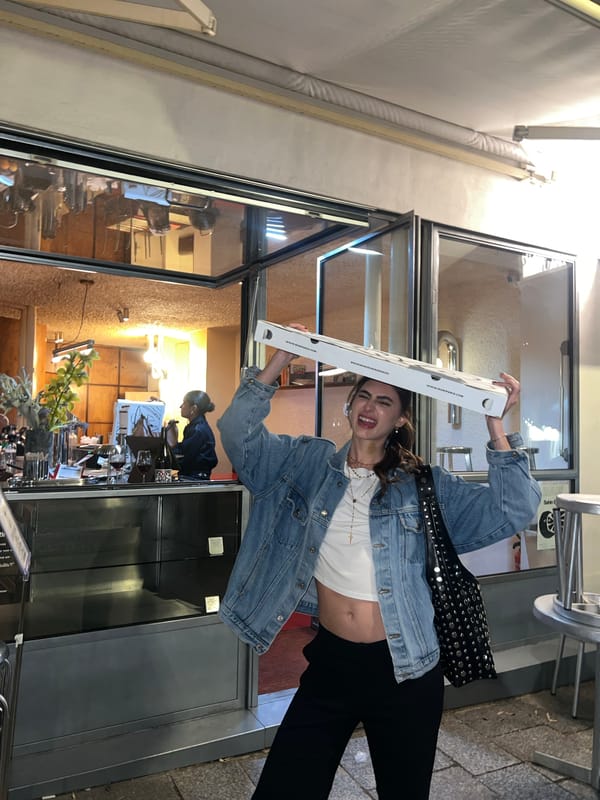 Women celebrate pizza pickup outside Paris restaurant