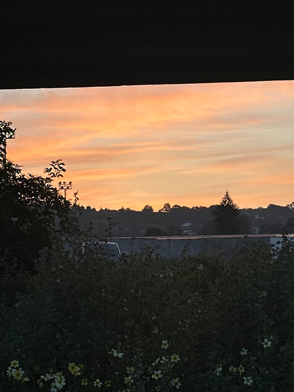 Sunset observed over Gijón, Spain with warm sky colors