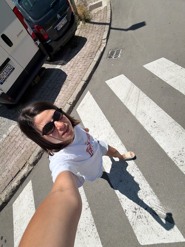 Tourists document sunny morning in Budva, Montenegro cafes and streets