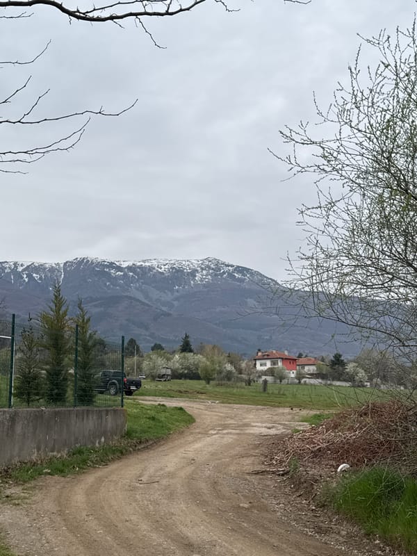 Rural Sofia scene documented with mountains and dirt road