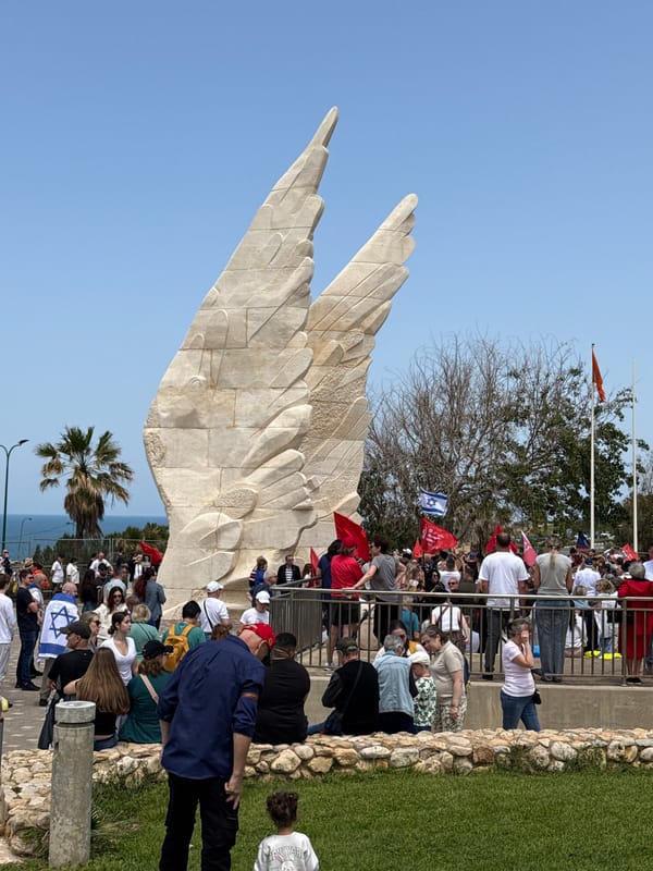 Memorial gathering with flags and portraits in Netanya