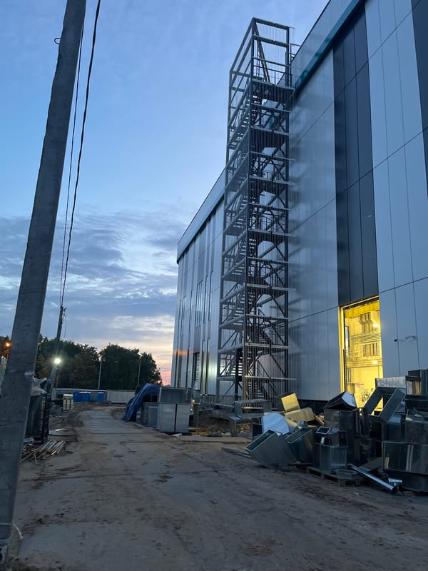 Kazan construction site at dusk, workers and machinery mid-build