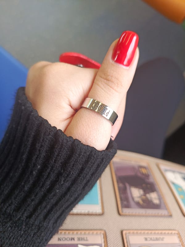 Train passenger displays distinctive jewelry and red nails in Russia