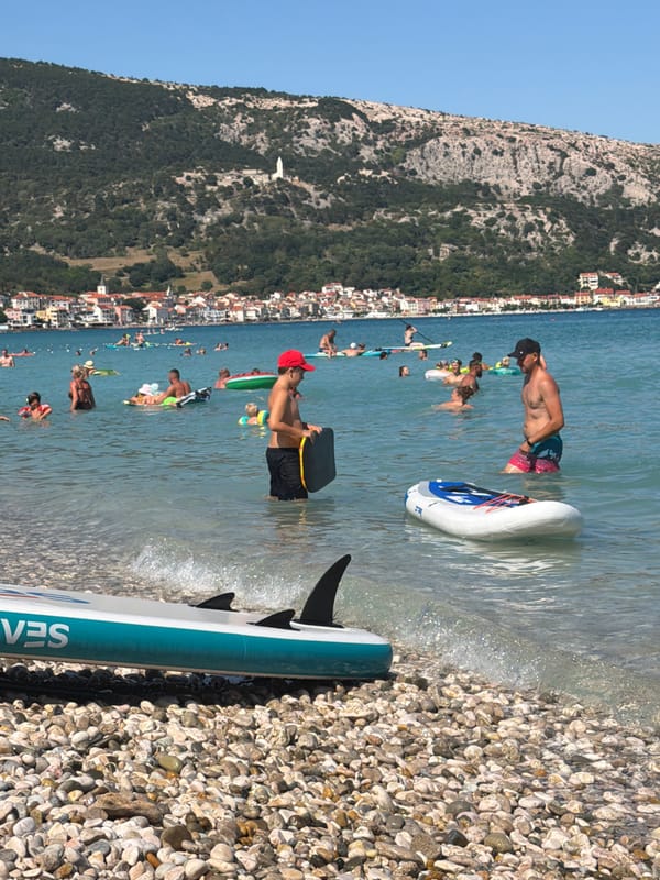 Crowded summer afternoon at Baška's pebble beach, Croatia