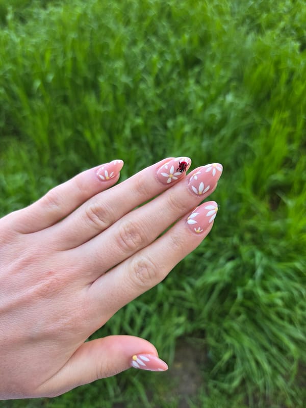 Person shows off manicured nail art outdoors