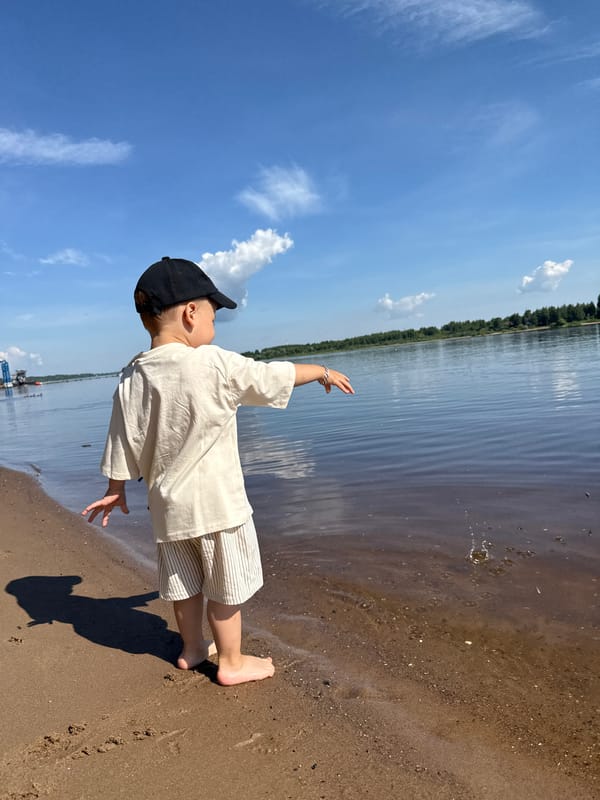 Mother and child enjoy morning outing by Russian waterfront