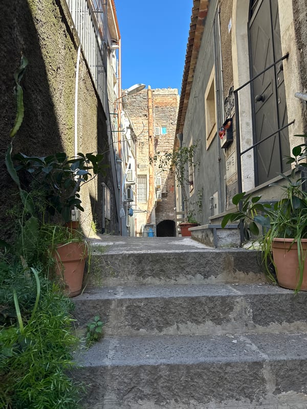 Tourist documents afternoon walk through historic Catania streets