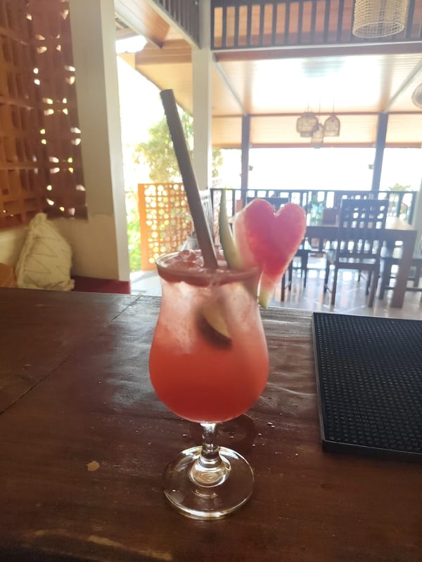 Pink cocktail with heart garnish captured in Kuta Selatan