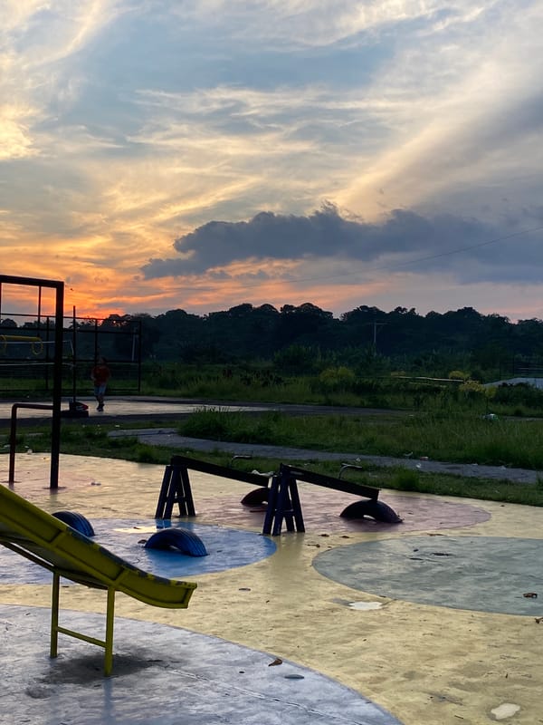 Davao neighborhood park and streets at sunset