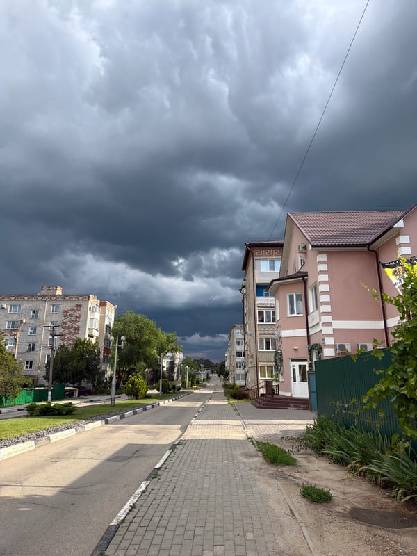 Storm clouds gather over Leningradskaya as daily life continues