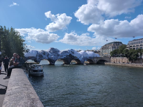 Paris bridge displays temporary decorations over Seine River