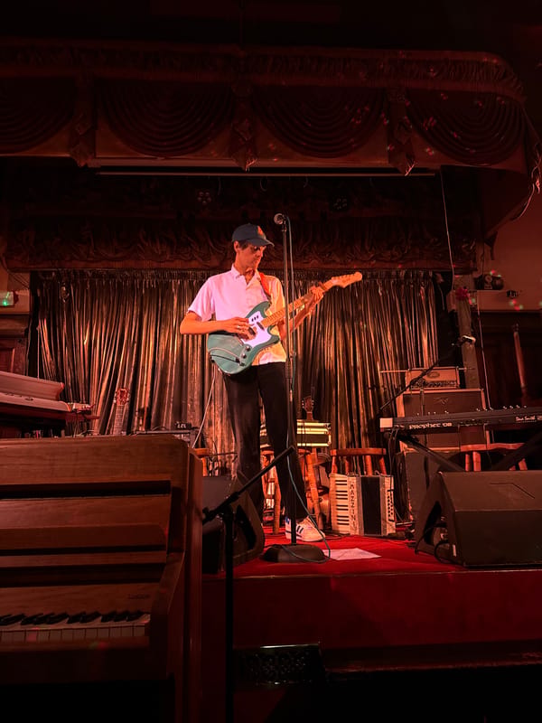 Musician performs live guitar set on London stage