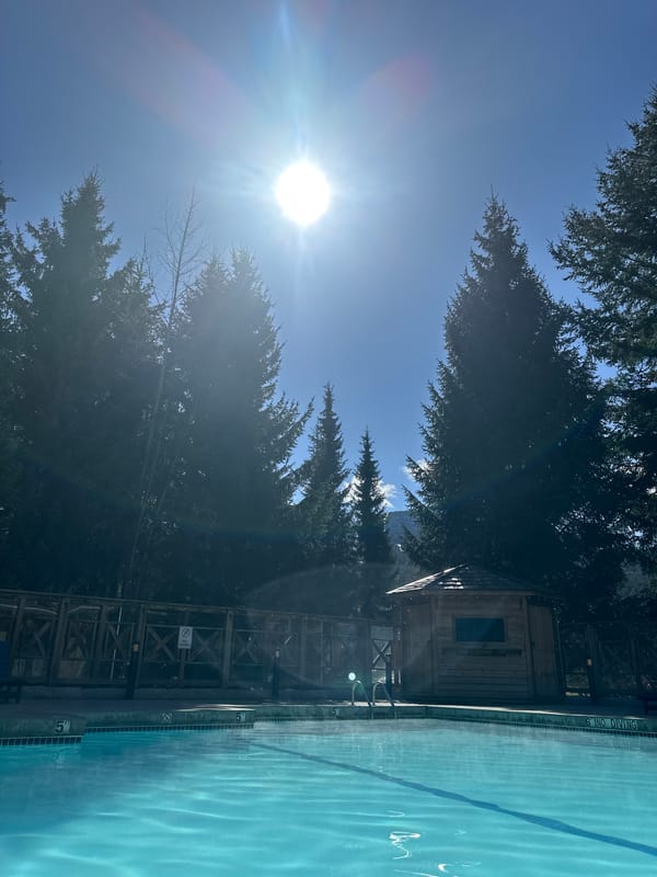 Outdoor pool facility documented in sunny Whistler mountain setting