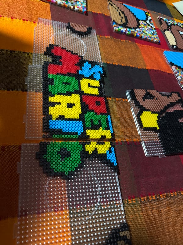 Perler bead Super Mario logo crafted in Puebla