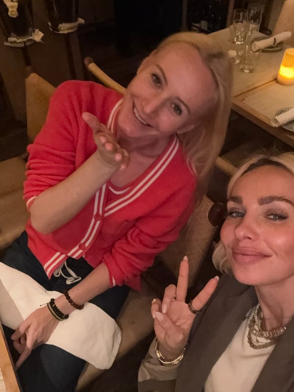 Two women pose together for selfie photo