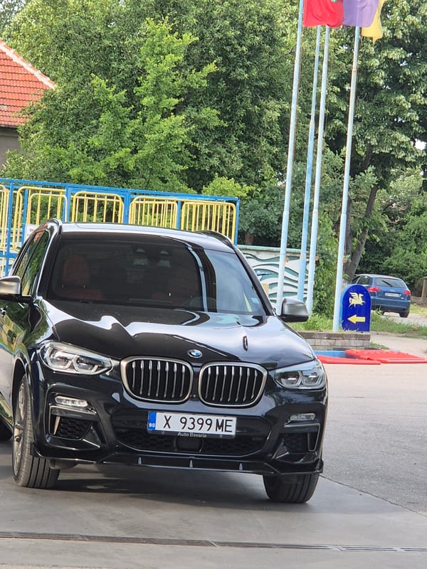 Mixed urban observations: BMW, TV footage, energy drinks, formal couple
