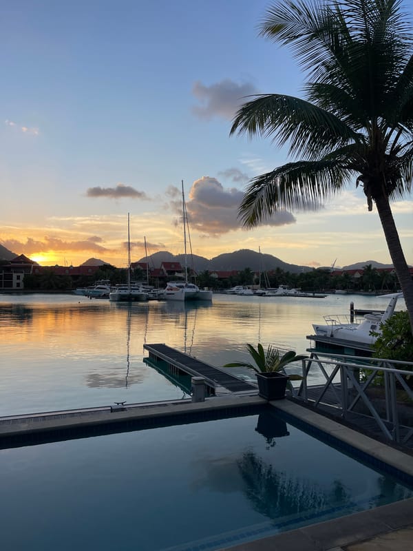 Sunset over Providence marina, Seychelles, with a plane overhead
