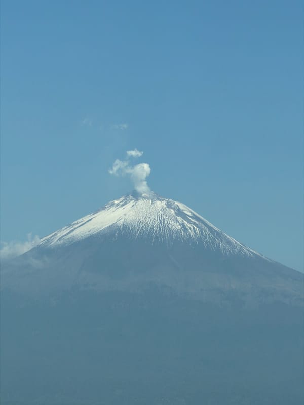 Snow-covered volcano emits smoke plume in Mexico