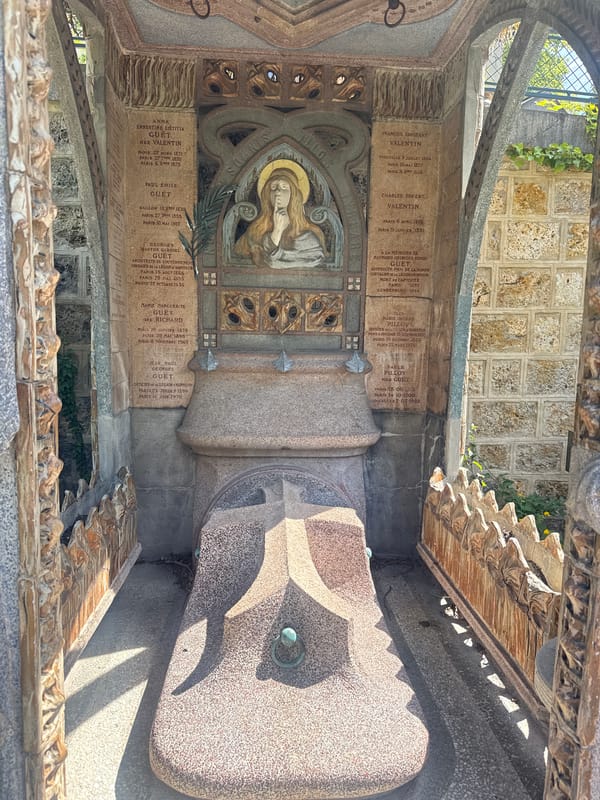 Visitor documents ornate tombs at Paris Montmartre Cemetery