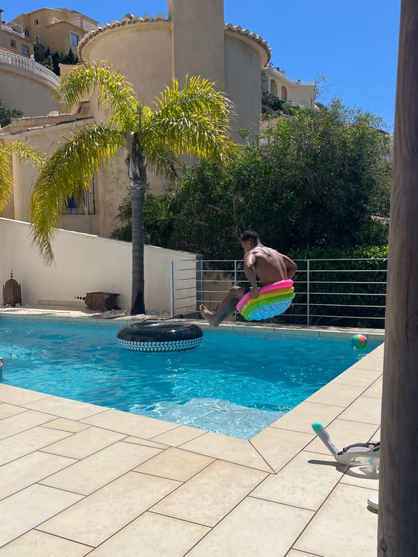 Man enjoys morning pool activities in Spanish coastal town
