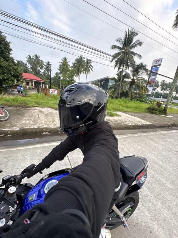 Evening motorcycle ride through palm-lined streets in Tagum City
